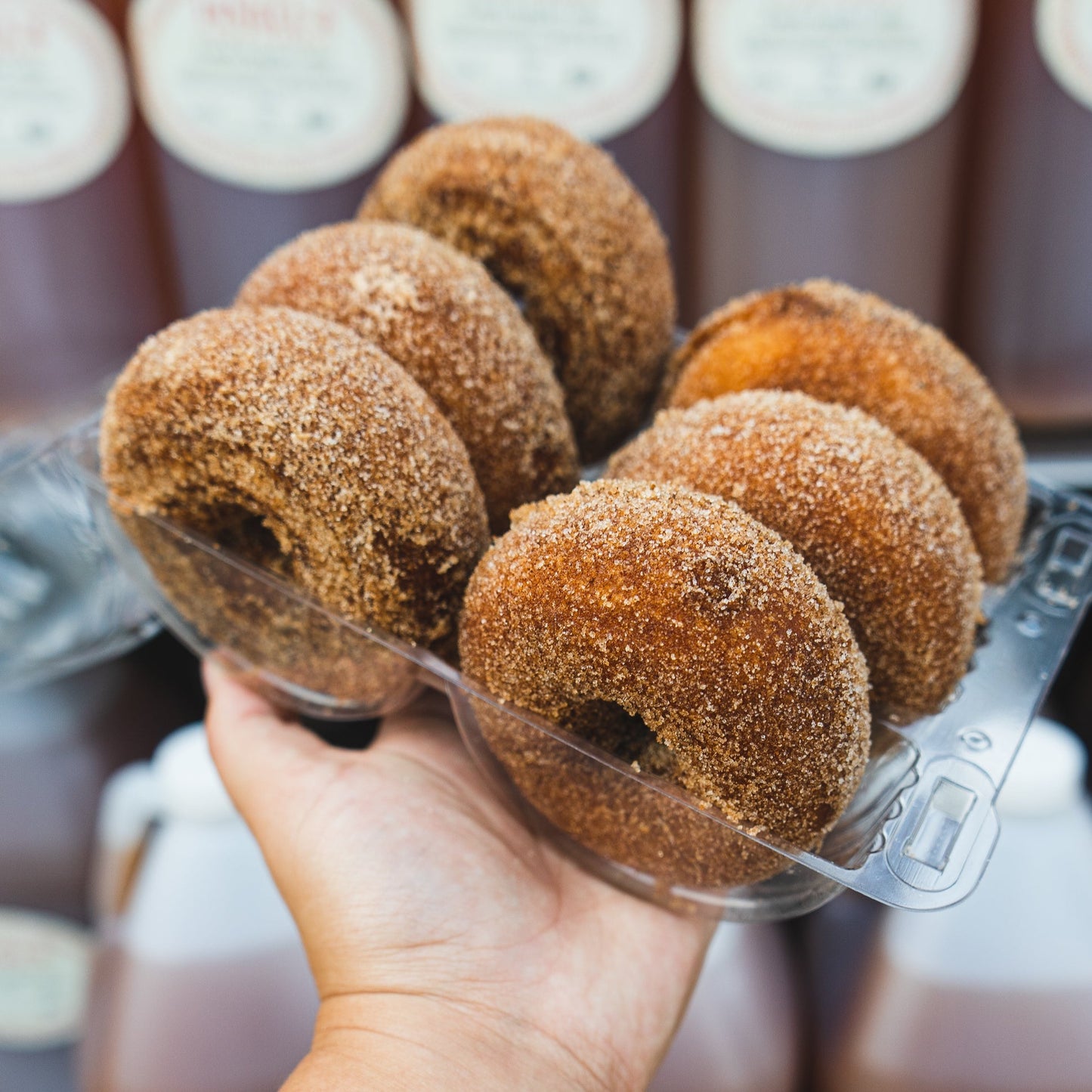 A 6 pack of freshly baked apple cider cake doughnuts. 